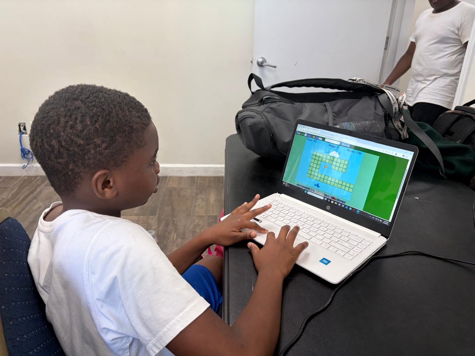 A child working on a laptop at a table